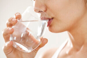 young woman drinking glass of water